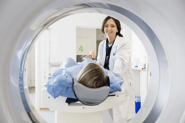 A doctor loads a patient into an MRI machine. You need to work safely, but it's also up to your employer to create an environment with a low likelihood of accidents occurring.
